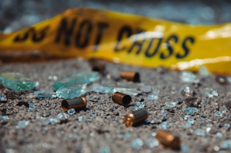 Bullet casings and broken glass. Office crime scene.